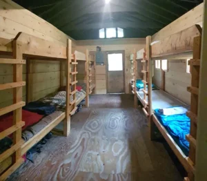 a cabin and bunk beds at can aqua summer camp